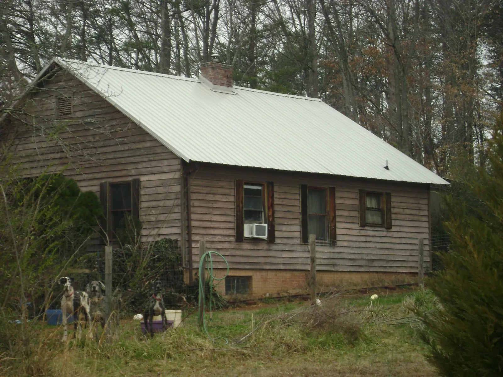 White metal roof on an old wood sided farmhouse, from a Metal Roof Installation job in Lindale